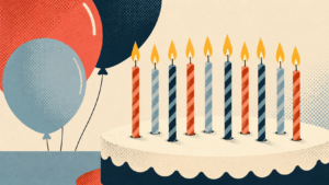 Image of candles on a cake with balloons in the background