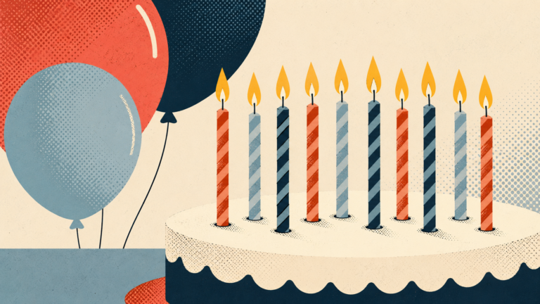 Image of candles on a cake with balloons in the background